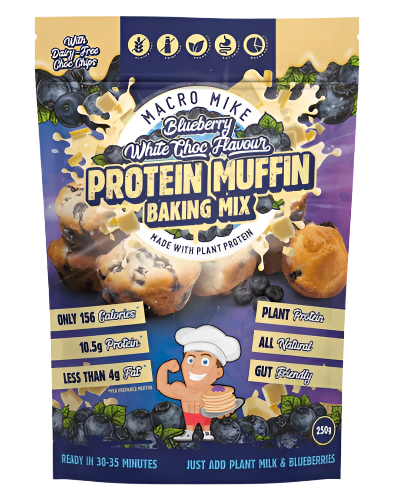 Packaging of Macro Mike's Protein Muffin Baking Mix with illustrations of blueberries, muffins, and a character mixing ingredients. The package highlights the product's features such as high protein, gluten-free, dairy-free, vegan, and gut-friendly.