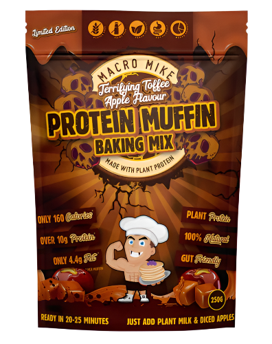 Packaging of Macro Mike's Protein Muffin Baking Mix with illustrations of blueberries, muffins, and a character mixing ingredients. The package highlights the product's features such as high protein, gluten-free, dairy-free, vegan, and gut-friendly.