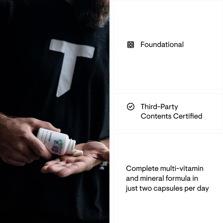 Person holding Thorne Basic Nutrients bottle in hand, representing daily use of foundational multivitamin