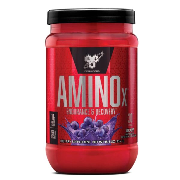 A red plastic container of BSN AMINOx powder with a black lid, labeled for endurance and recovery, featuring an image of grape, indicating the flavor.