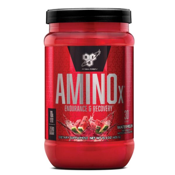 A red plastic container of BSN AMINOx powder with a black lid, labeled for endurance and recovery, featuring an image of watermelon, indicating the flavor.