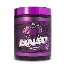 A container of Dialed pre-workout supplement with a predominantly purple color scheme and a cartoon bear graphic.