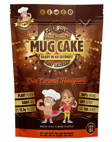 Packaging for Macro Mike Plant Protein Mug Cake mix featuring illustrations of a smiling character and a chef, with chocolate chips and a mug depicted. The package highlights the product as plant-based, dairy-free, and containing chocolate flavor.