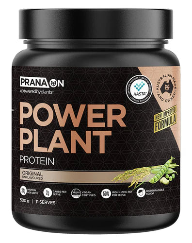 A container of Prana On Power Plant Protein powder unflavored. The packaging is black with gold and white text and an image of a chocolate bar.