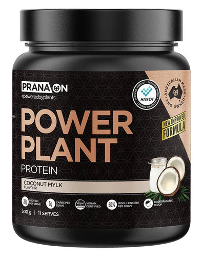 A container of Prana On Power Plant Protein powder in coconut mylk flavor. The packaging is black with gold and white text and an image of a chocolate bar.