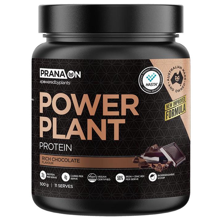 A container of Prana On Power Plant Protein powder in Rich Chocolate flavor. The packaging is black with gold and white text and an image of a chocolate bar.